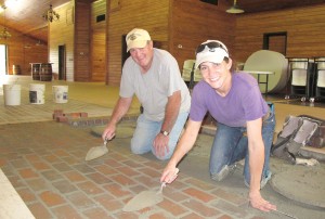 World Champion bricklayer Jerry Goodman of Blythewood and his daughter and co-worker, Heidi Abea, practice their craft on the floor of The Farm at Ridgeway. (Photo/Barbara Ball)