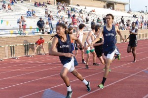 Joshua Bowers takes the handoff from Devin Lowry in the 4x800. (Photo/Kristy Kimball Massey)