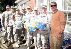 These National Guardsmen showed up Tuesday morning at the Christian Assistance Bridge to help load cases of water for families in the community picking up food and water from the CAB office on Blythewood Road. At right is CAB board member Ken Trogden. (Photo/Barbara Ball)
