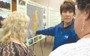 At a community meeting last week at The Manor, Heins Road  resident Laurie Rossdentsher discusses with neighbors a map of a proposed residential development that they fear could adversely affect the tranquility of their rural properties. (Photo/Barbara Ball)