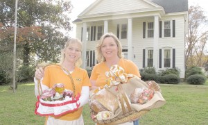 Sisters-in-law Valerie Clowney and Katherine Bass have turned their passion for gardening into a business that is thriving during the holiday season. Standing in front of the family farm, the two prepare to pack up their garden produce and products and head out for another holiday market.