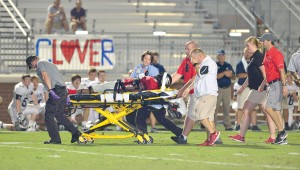 Mark "MJ" Mickens is taken off the field following his injury during the Sept. 4 game vs. Clover. (Photo/Ross Burton)