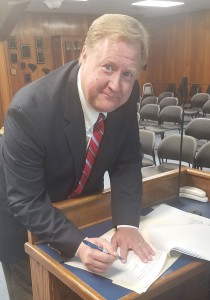 Newly hired Fairfield County Administrator Jason Taylor signs his contract with the County Monday evening following a County Council executive session. Council voted unanimously to extend to Taylor a three-year contract. (Photo/Fairfield County)