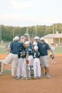 The Minors and coaching staff celebrate last week’s state title win.
