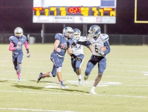 Kameron Riley (6) takes a Jordyn Adams pass and fights off a tackle at White Knoll on Oct. 21. (Photo/Jason Arthur)