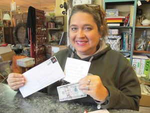 Liz Humphries, owner of Blythewood Consignment Shop on Main Street in Blythewood, recently loaned a stranger $5 for fuel for his pickup truck. “And then,” she said, “to my surprise, I got this!” (Photo/Barbara Ball)