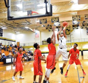 Fairfield Central's Chandon Davis (1) puts up a shot surrounded by Redhawks Russell Jones (2), Xavier Dobey (5), Terrance Barnes (1) and Terrell Harris (3). (Photo/Joe Seibles)
