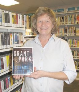 Fiona Smith, Library Associate at the Blythewood Library, holds a copy of ‘Grant Park,’ a thirller about racial tensions and the subject of the community’s second Blythewood Reads event to be held in February. (Photo/Barbara Ball)
